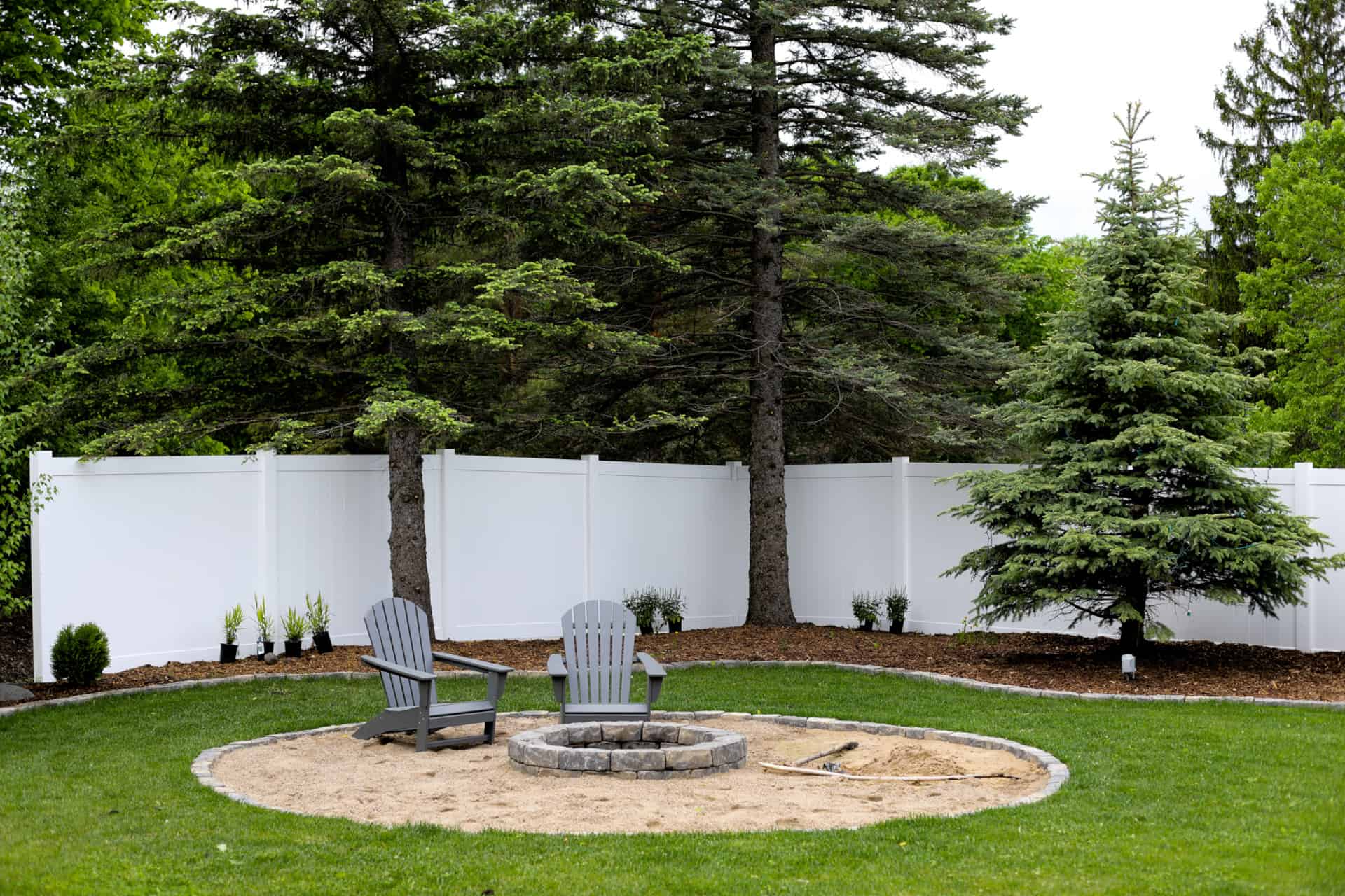 backyard privacy fencing around patio set and firepit